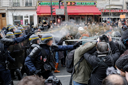 Policemen fight with activists during a protest ahead of the 2015 Paris Climate Conference