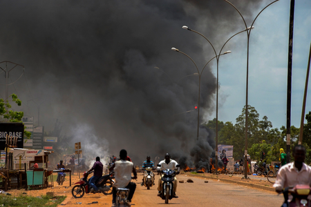 Commuters flee from burning barricades during protests against a coup in Ouagadougou, Burkina Faso.