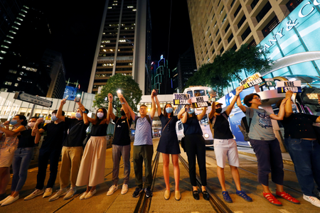 Protesters hold hands to form a human chain during a rally to call for political reforms in Hong Kong&#039;s Central district, China, August 23, 2019.