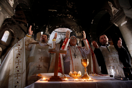 Iraqi priests hold the first mass at the Grand Immaculate Church since it was recaptured from Islamic State in Qaraqosh