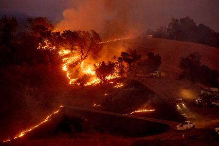 Flames from a backfire, lit by firefighters to slow the spread of the Kincade Fire, burn a hillsid Sonoma County near Geyservillle on Oct. 26.