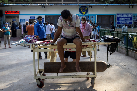 A patient suffering from the coronavirus disease (COVID-19) waits to get admitted outside the casualty ward at Guru Teg Bahadur hospital, amidst the spread of the disease in New Delhi, India.