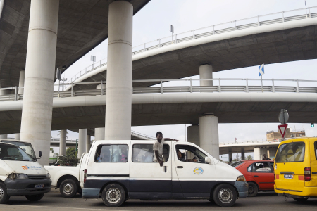 A commuter van drives underneath the newly constructed Henri Konan Bedie bridge in Abidjan.
