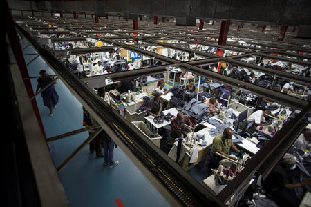 Employees work on the manufacturing line at a textile factory in Nairobi, Kenya.