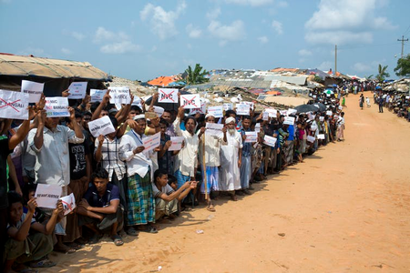 Rohingya refugees holding placards, await the arrival of a U.N. Security Council team in Bangladesh, on April 29, 2018.