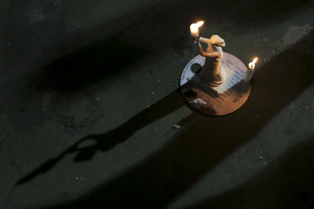 A miniature Goddess of Democracy candlestick is displayed during a candlelight vigil in Hong Kong
