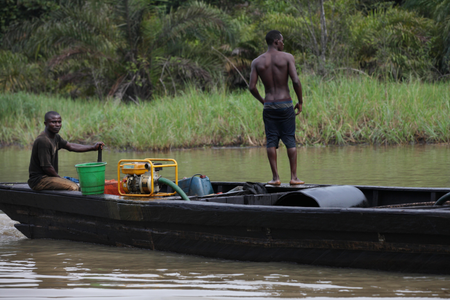 suspected oil thieves ride a wooden boat