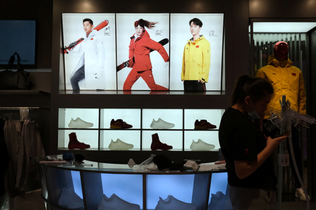 An advertisement shows freestyle skier Eileen Gu at an Anta store inside a shopping mall in Beijing.