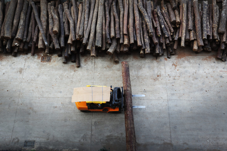 Mukula timber that is piled in a storage yard of a rosewood furniture factory.