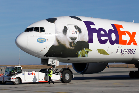 Airport workers watch as the FedEx Panda Express aircraft carrying two giant pandas taxis at the Charles-de-Gaulle airport