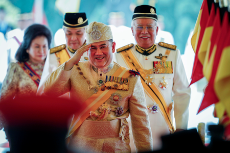 Sultan Muhammad V, center, salutes after his welcome ceremony as he walks with Malaysian Prime Minister Najib Razak, right, at the Parliament House in Kuala Lumpur, Malaysia, Tuesday, Dec. 13, 2016. Sultan Muhammad V of Kelantan will serve a five-year term as King of Malaysia from Tuesday. (AP Photo/Vincent Thian)