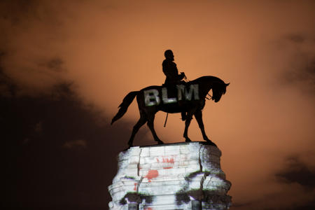Artist Dustin Klein projects a Black Lives Matter image onto the statue of Confederate General Robert E. Lee in Richmond, Virginia, U.S. June 18, 2020. REUTERS/Julia Rendleman
