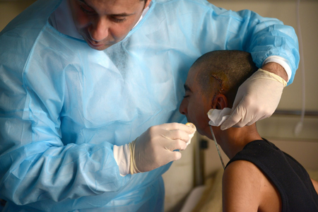 Surgeon and Iraqi boy with jaw injury