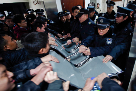 People clash with police as they try to visit relatives injured in a stampede, at a hospital in central Shanghai on New Year&#039;s Day.