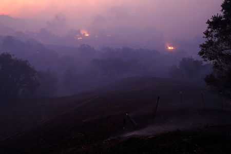 The sun rises above a smoke-filled valley during the Kincade fire in Geyserville.
