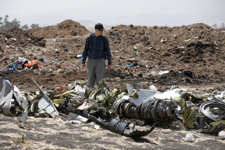 FILE PHOTO: American civil aviation and Boeing investigators search through the debris at the scene of the Ethiopian Airlines Flight ET 302 plane crash, near the town of Bishoftu, southeast of Addis Ababa, Ethiopia March 12, 2019.
