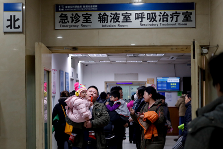 Parents with their children wait at a holding room of a children&#039;s hospital in Beijing, Sunday, Dec. 18, 2016. A smog-shrouded Chinese city canceled airline flights Sunday due to poor visibility and many parents took children to hospitals on the second day of a pollution alert across the country&#039;s north. (AP Photo/Andy Wong)