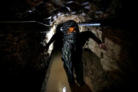 A Palestinian works inside a smuggling tunnel flooded by Egyptian forces, beneath the Egyptian-Gaza border in Rafah, in the southern Gaza Strip February 19, 2013.