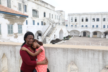 Afi Koufahenou and her daughter Divine pose for a photograph at Cape Coast Castle