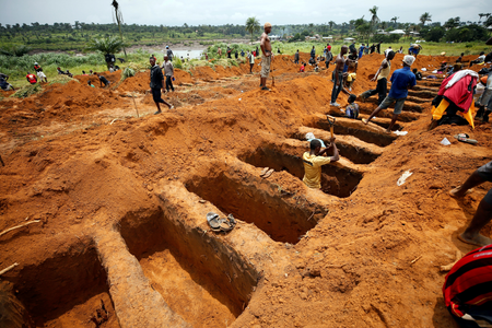 Workers are digging graves at the Paloko cemetery in Waterloo, Sierra Leone August 17, 2017.