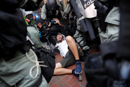 Riot police detain an anti-government protester during a demonstration at Wan Chai district, on China&#039;s National Day in Hong Kong, China October 1, 2019.