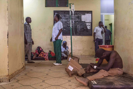 A protestor, right, injured during clashes receives treatment in a hospital in Ouagadougou.