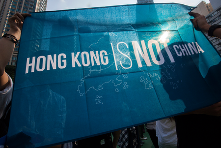 A man holds a &#039;Hong Kong is Not China&#039; flag during a protest against the Legislative Council oath-taking interpretation of the city&#039;s Basic Law, or mini-constitution, by the Chinese authorities in Beijing, in Hong Kong, China, 06 November 2016. During their swearing-in ceremony in October 2016, councillors-elect Leung and Yau altered their oaths in a provocative move against mainland China and displayed pro-independent Hong Kong flags. The Standing Committee of the National People&#039;s Congress (NPC) plans to discuss to overturn the oathtaking and hence bar the elected councillors, which has sparked protests in Hong Kong. EPA/ALEX HOFFORD