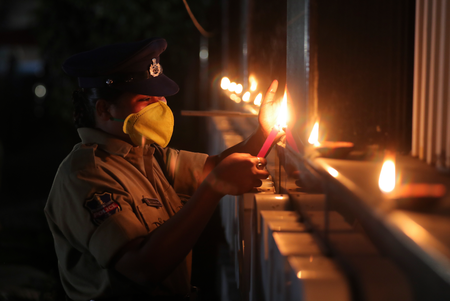 An Indian policewoman lights earthen lamps in Hyderabad.