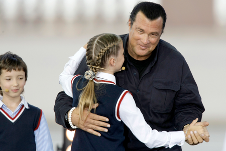 Steven Seagal, a new Russian citizen, dances with a young girl in Moscow