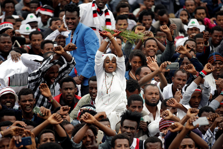 A demonstrator chants slogans while flashing the Oromo protest gesture during celebrations for Irreecha, the thanksgiving festival of the Oromo people, in Bishoftu town, Oromia region, Ethiopia, October 1, 2017.