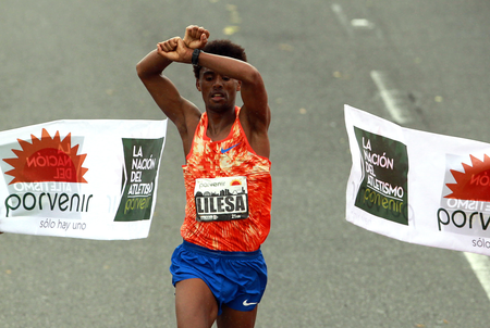 Ethiopian Feyisa Lilesa, current Olympic runner-up, was crowned champion of the Half Marathon of Bogota, Colombia, 30 July 2017. Feyisa Lilesa clasped his hands above his head in protest of the government&#039;s repression against his tribe when he crossed the line, just as he did at the Rio Olympics.