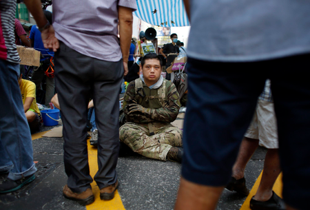 A pro-democracy protester guards a tent from possible attack by anti- protesters in Mong Kok on Oct. 5.