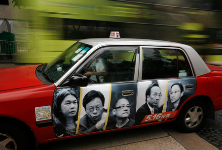 Portraits of resigned pro-democracy lawmakers (L-R) Leung Kwok-hung, Raymond Wong, Albert Chan, Alan Leong and Tanya Chan are printed on a taxi as an advertistment ahead of a by-election in Hong Kong May 5, 2010. Five Hong Kong lawmakers resigned from the legislature in late January in a bid to pressure China to grant the former British colony greater and swifter democratic concessions. The by-election on May 16 is being seen as a de facto referendum on full democracy in the territory.