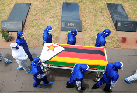 Pallbearers carry a coffin at the burial of two cabinet ministers and a retired general who died after contracting Covid-19 in Harare, Jan. 27.