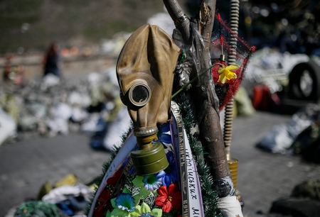 A gas mask and flowers are seen at the site of the recent clashes in Kiev March 30, 2014.