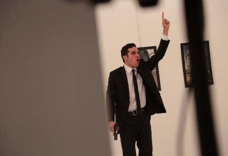 An unnamed gunman gestures after shooting the Russian Ambassador to Turkey, Andrei Karlov, at a photo gallery in Ankara, Turkey, Monday, Dec. 19, 2016. A gunman opened fire on Russia&#039;s ambassador to Turkey at a photo exhibition on Monday. The Russian foreign ministry spokeswoman said he was hospitalized with a gunshot wound. (AP Photo/Burhan Ozbilici)