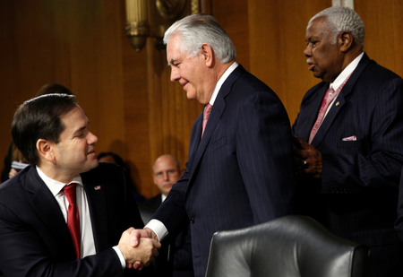 Rex Tillerson (C), the former chairman and chief executive officer of Exxon Mobil, shakes hands with U.S. Senator Marco Rubio (R-FL) as he arrives for a Senate Foreign Relations Committee confirmation hearing to become U.S. Secretary of State on Capitol Hill in Washington January 11, 2017.