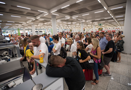 Passengers of British travel group Thomas Cook queue at Son Sant Joan airport in Palma de Mallorca on Sept. 23, 2019.