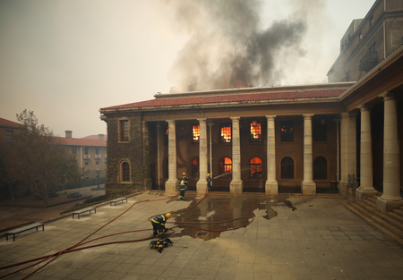 Firefighters battle flames as the library at UCT.