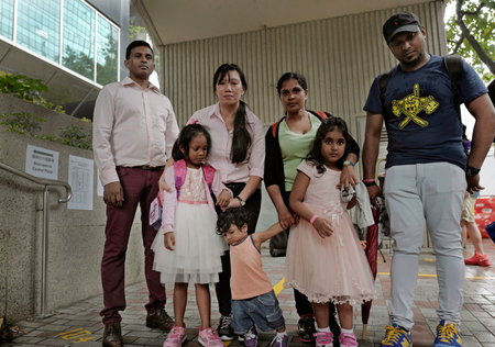 Asylum seekers, from left: Ajith Pushpa Kumara, Vanessa Mae Rodel and her daughter Keana, Nadeeka Dilrukshi Nonis and her son Dinath and daughter Sethmundi Kellapatha, and Supun Thilina Kellapatha, pose outside the building of Hong Kong&#039;s immigration department in Hong Kong, Monday, May 15, 2017. The Hong Kong lawyer for a group of refugees who sheltered former NSA contractor Edward Snowden four years ago says the southern Chinese city&#039;s immigration department has rejected their asylum requests. The applicants are from the Philippines and Sri Lanka.