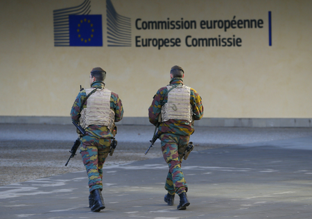 Belgian soldiers patrol outside the European Commission headquarters as police searched the area during a continued high level of security following the recent deadly Paris attacks, in Brussels, Belgium, November 23, 2015.