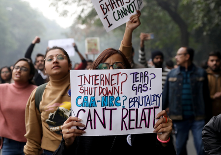 Demonstrator display placards and shout slogans during a protest against a new citizenship law, in New Delhi