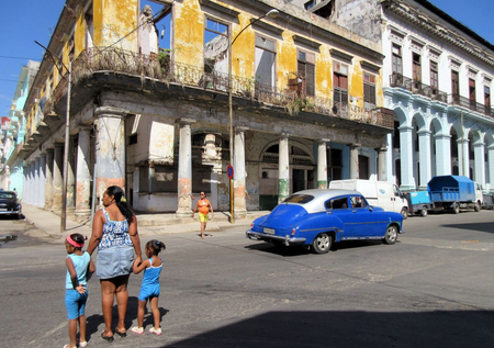 In this photo taken May 13, 2015 people walk past a shell of a building with the sky visible in Havana, Cuba. House Republicans have voted to keep restrictions on Americans seeking to travel to Cuba. That&#039;s a setback to Obama administration efforts to ease the five-decade Cold War standoff. The GOP-controlled chamber voted 247-176 to keep a Cuba-related provision in a transportation funding bill. The provision would block new rules issued in January that would significantly ease travel restrictions to Cuba and allow regularly scheduled flights for the first time.