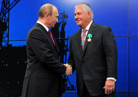 In this photo taken Thursday, June 21, 2012, Russian President Vladimir Putin presents ExxonMobil CEO Rex Tillerson with a Russian medal at an award ceremony of heads and employees of energy companies at the St. Petersburg economic forum in St. Petersburg, Russia. An aide to President Vladimir Putin praised United States President-elect Donald Trump’s choice of Rex Tillerson to lead the State Department and says that the businessman is well regarded by many Russian officials. ﻿
