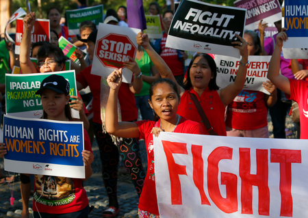 Women shout slogans with placards during a rally in solidarity against the inauguration of President Donald Trump, Saturday, Jan. 21, 2017 in suburban Quezon city, northeast of Manila, Philippines. Pledging emphatically to empower America&#039;s &quot;forgotten men and women,&quot; Donald Trump was sworn in as President of the United States Friday, taking command of a riven nation facing an unpredictable era under his assertive but untested leadership.