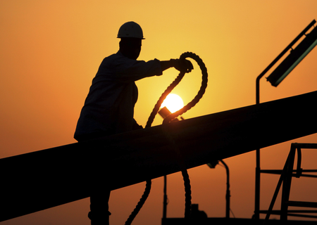 In this file photo taken July 7, 2010, an unidentified oilfield worker ties pipes to be raised on an oil rig as the sun sets in the Persian Gulf desert oil field of Sakhir, Bahrain. Exxon earned the majority of its income from exploration and production operations in foreign waters, particularly in Africa, Asia and the Middle East. Exxon&#039;s results showed a jump in profits across its exploration and production, refining and chemicals businesses.