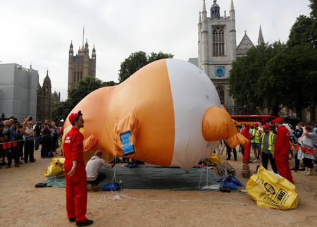 Demonstrators inflate a blimp portraying U.S. President Donald Trump, in Parliament Square, during the visit by Trump and First Lady Melania Trump in London