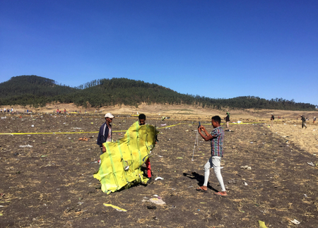 A civilian takes a photograph of the wreckage at the scene of the Ethiopian Airlines Flight ET 302 plane crash, near the town of Bishoftu, southeast of Addis Ababa, Ethiopia March 10, 2019.