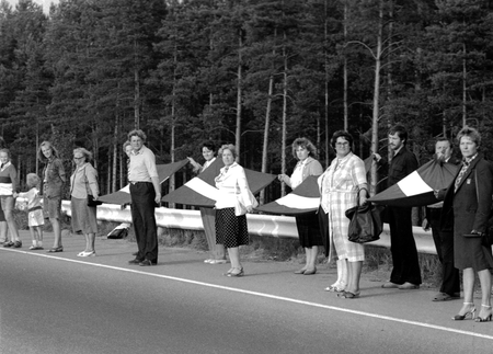 People hold hands and Latvian flags as they participate in a human chain at Baltic Way near Riga August 23, 1989. Runners left Lithuania and Estonia on August 22, 2009, for neighbouring Latvia to start events marking the 20th anniversary of a 600 km (375 mile) human chain that showed the Balts&#039; wish to regain their independence from the Soviet Union. More than two million people in the Baltic countries of Estonia, Latvia and Lithuania joined hands in one of the biggest mass protests seen against the former Soviet Union and demanded the restoration of independence. Picture taken August 23, 1989.
