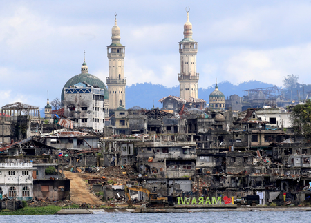 A signage of &quot;I love Marawi&quot; is seen in front of damaged houses, buildings and a mosque inside a war-torn Marawi city, southern Philippines October 26, 2017, after the Philippines on Monday announced the end of five months of military operations in a southern city held by pro-Islamic State rebels.